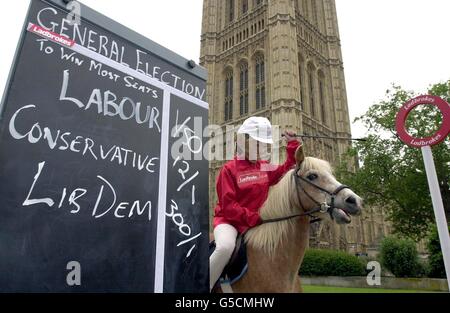 A jockey wearing a Prime Minister Tony Blair mask takes part in a 'one-horse race' outside the Houses of Parliament in London. Ladbrokes took the unprecedented step of deciding to pay out early on all bets placed on Labour winning the election. *The bookmakers had already cut Labour's odds from 1/40 to 1/50 ( 50 staked to win just 1), before deciding to pay out early on the result - the first time it has ever done so at a general election. Stock Photo