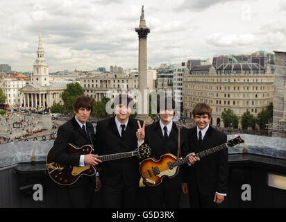 Cast members of the new Beatles musical 'Let It Be' (left to right) Stephen Hill as George Harrison, Reuven Gershon as John Lennon, Emanuelle Angeletti as Paul McCartney and Gordon Elsmore as Ringo Starr at a photocall at the Trafalgar Hotel, central London. Stock Photo