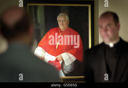 Chancellor of the Diocese Peter Smith (right) gives his reaction to the death of Cardinal Thomas Winning, in front of a painting of the Cardinal, who has died. Cardinal Winning, 76, leader of Scotland's Roman Catholics, died suddenly after suffering another heart attack. * at his home in Newlands, Glasgow. (L-R) Stephen Hannah, Chaplain of the Victoria Infirmary; Dr Brian Cowan, Medical Director of the Victoria Infirmary; and James Clancy, Administrator of the Cathedral. Stock Photo