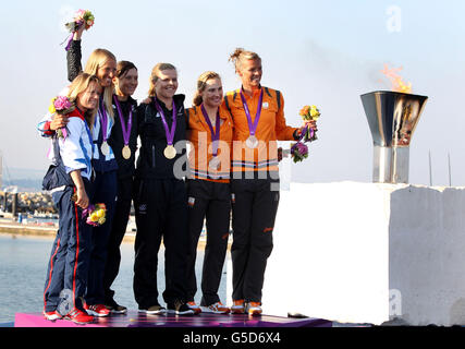 Olympic medal winners in the Women's 470 class during tonight's ceremony (from left to right) Great Britain's silver medalists Hannah Mills and Saskia Clark, New Zealand's gold medalists Jo Aleh and Olivias Powrie and Netherlands bronze medalist Lisa Westerhof and Lobke Berkhout. Stock Photo