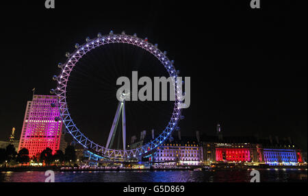 To mark the end of the London 2012 Olympic Games, EDF Energy have lit up the EDF Energy London Eye, County Hall and Shell Building on London's Southbank. Stock Photo