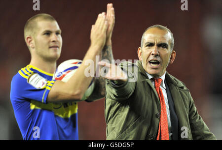Swindon Town manager Paolo Di Canio celebrates after his team's 4-3 extra time win against Stoke City with hat trick goalscorer James Collins (left) after the Capital One Cup Second Round match at the Britannia Stadium, Stoke-on-Trent. Stock Photo
