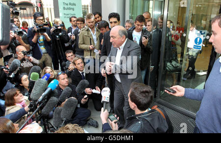 Russian oligarch Boris Berezovsky, (centre), addresses the media as he leaves the High Court, central London, where he lost his battle with Chelsea Football Club owner Roman Abramovich, after seeking more than &pound;3 billion damages after accusing the 45-year-old Russian billionaire businessman of blackmail, breach of trust and breach of contract. Stock Photo