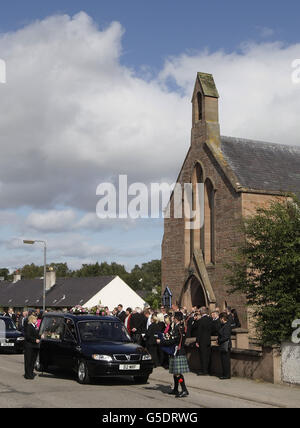 The scene, including the floral tributes, following the funeral of five-year old Grace Mackay, who died after a canoeing accident, at East Church in Muir of Ord, Scotland. Stock Photo