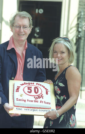 Actor Corin Redgrave and TV presenter Mariella Frostrup deliver a birthday cake marking the 50th anniversary of the 1951 United Nations Convention on Refugees, to 10 Downing Street, central London. * They were also delivering 4,000 pledges aiming to safeguard refugees' rights collected by the Refugee Council from members of the public. 23/7/03: Human rights campaigner Corin Redgrave was joining legal experts to call for fair trials for two Britons being held by United States authorities at Guantanamo Bay, Cuba. Moazzam Begg, from Sparkhill, Birmingham, and Feroz Abbasi, from London, have both Stock Photo