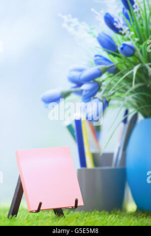 Adhesive note with empty space at green office Stock Photo
