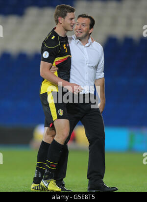 Belgium manager Marc Wilmots celebrates with goalscorer Jan Vertonghen after their 2-0 win over Wales during the 2014 Fifa World Cup Qualifying match at the Cardiff City Stadium, Cardiff. Stock Photo