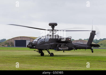 Apache lifts off from the grass Stock Photo