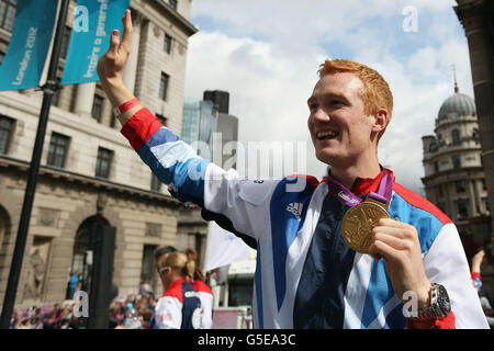 British Olympic gold medal winning athlete Greg Rutherford waves to the crowd during the London 2012 Victory Parade for Team GB and Paralympic GB athletes in London. Stock Photo