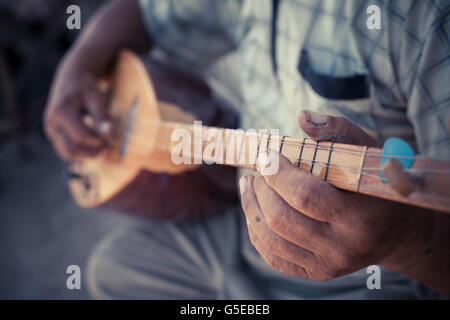 Close up shot of a man playing a Tatar instrument called 'baglama'. Stock Photo