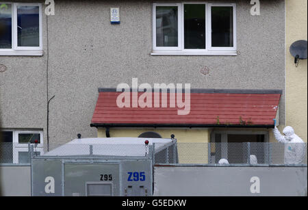 Police forensic officers continue to work at the scene of the shooting of Pcs Fiona Bone, 32, and Nicola Hughes, 23, in Hattersley, Greater Manchester. Stock Photo