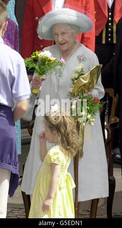 A young girl gives flowers to Queen Elizabeth II as she leaves the ...
