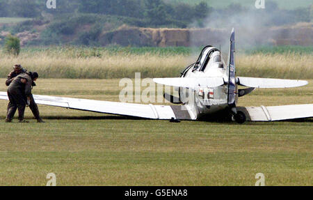 A pilot and passenger abandon their two seater Harvard T6 plane which crashed as it took off from RAF Duxford, Cambridgeshire, prior to an air show. It is not thought that anyone was injured in the accident * at the Imperial War Museum's aviation headquarters at Duxford. Stock Photo