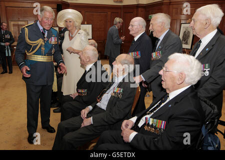 The Prince of Wales and the Duchess of Cornwall talk to RAF veterans who sat for portraits at the Prince's Drawing School at the Church House after the Prince attended the Battle of Britain Service of Thanksgiving and Rededication at Westminster Abbey in London. Stock Photo