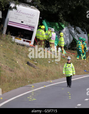 Emergency services at the scene of a coach crash on the A3 near Hindhead in Surrey, where three people died and others were left seriously injured when the coach overturned after colliding with a tree on an embankment. Stock Photo