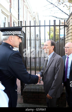 Surrey Police Assistant Chief Constable Rob Price (left) greets examining magistrate Michel Mollin from France, at Woking Police Station, Surrey. Stock Photo