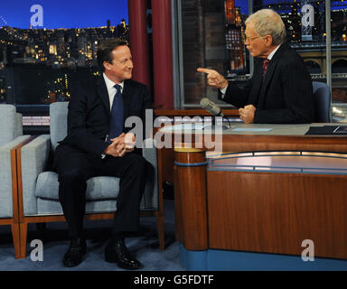 Prime Minister David Cameron (left) talks with talk show host David Letterman on the David Letterman Show in New York, after he addressed the United Nations General Assembly. Stock Photo