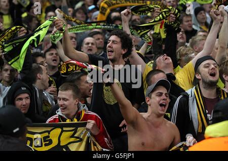 Borussia Dortmund fans in celebratory mood in the stands Stock Photo