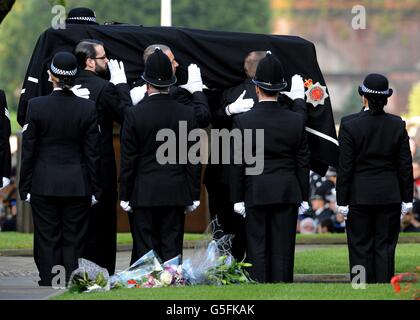 The coffin of Pc Fiona Bone, one of the two policewoman murdered in a gun and grenade attack, in Hattersley, Tameside, Manchester, on September 18, is carried into Manchester Cathedral, for her funeral service . Stock Photo
