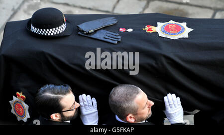 The coffin of Pc Fiona Bone, one of the two policewoman murdered in a gun and grenade attack, in Hattersley, Tameside, Manchester, on September 18, is carried into Manchester Cathedral, for her funeral service. Stock Photo