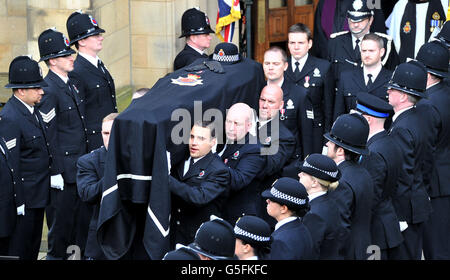 The coffin of Pc Fiona Bone, one of the two policewoman murdered in a gun and grenade attack, in Hattersley, Tameside, Manchester, on September 18, is carried from Manchester Cathedral, following her funeral service. Stock Photo