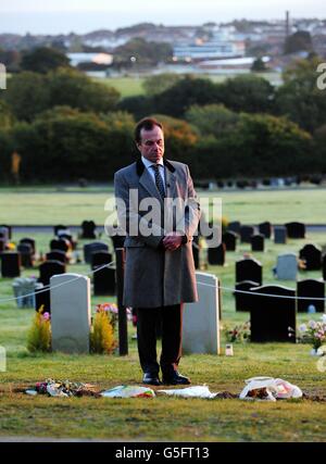 Funeral director Robert Morphet stands next to the grave of Sir Jimmy Savile in Woodlands Cemetery, Scarborough, where he assisted the local council in removing the headstone at the request of Savile's family. Stock Photo