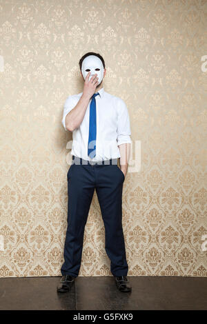 businessman hiding behind the mask Stock Photo