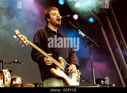 Lead singer and bass guitarist for the rock band Doves, Jimi Goodwin, performing live on stage at the V2001 concert in Hylands Park, Chelmsford, Essex. Stock Photo