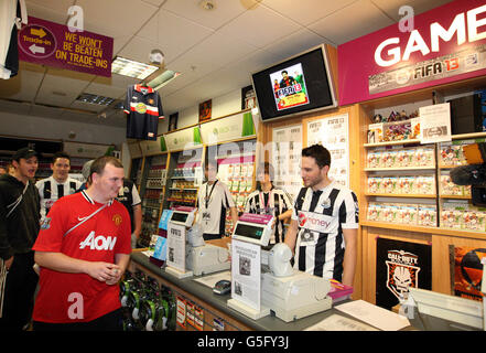 Martin Keenan from Gateshead is the first to buy a copy of FIFA 13 at GAME's Gateshead Metro Centre store in Newcastle Upon Tyne which opened at midnight so fans could get a copy the moment the game was released. Stock Photo