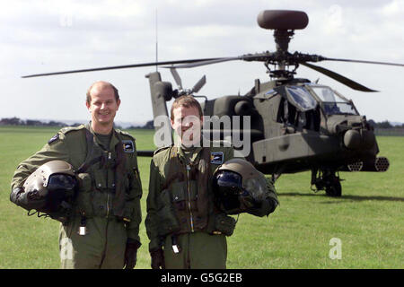 Captain Rory Burnett (left) and Major Nick Wharmby stand in front of the British Army's new state of the art attack Helicopter - the Apache Longbow - at the Duxford Air Museum. Stock Photo
