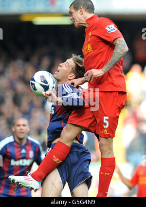 Stoke City's Peter Crouch battles for the ball with Liverpool's Daniel Agger (right) during the Barclays Premier League match at Anfield, Liverpool. Stock Photo