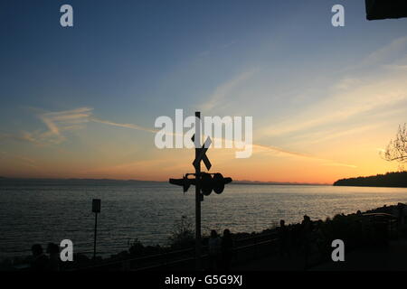 Sunset in Victoria, BC, Canada, with a silhouette in the background. Stock Photo