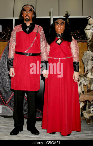 Jossie Sockertopp, 23 (right) and Sonnie Gustavsson, 29, from Sweden tie the knot in full Klingon costume as their Star Trek idols, during a ceremony conducted by Peter Wyllie in the Klingon language, at Destination Star Trek at the ExCel Centre in London. Stock Photo