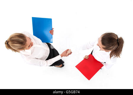 Top view of two business women shaking hands isolated on white background Stock Photo
