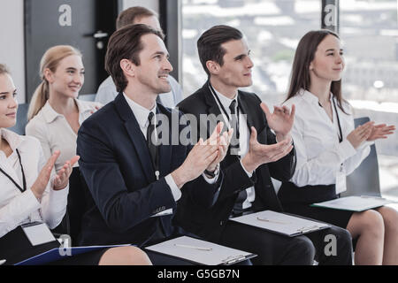 Happy business group of people clapping hands during a meeting conference Stock Photo