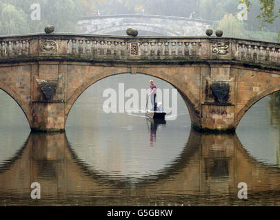 Fog lingers in the air as a punt makes it's way along the River Cam in Cambridge.