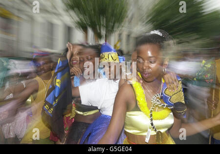 A group of revellers dance during the Notting Hill Carnival in west London. Stock Photo