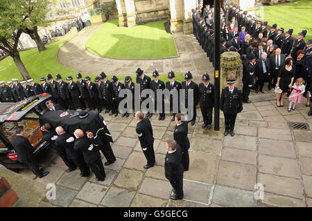 The coffin of Pc Fiona Bone, one of the two policewoman murdered in a gun and grenade attack, in Hattersley, Tameside, Manchester, on September 18, is carried from Manchester Cathedral following her funeral service. Stock Photo