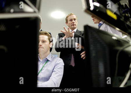 Taoiseach Enda Kenny is talked through risk betting in sports by Alan Glynn at the official opening of Power Tower, the company's new headquarters for the bookmaker Paddy Power in Clonskeagh, Dublin where the company also announced the creation of 600 new jobs. Stock Photo