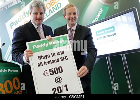 Taoiseach Enda Kenny is presented with a bet for his chosen charity for his native county Mayo to win next years All Ireland by Patrick Kennedy CEO at the official opening of Power Tower, the company's new headquarters for the bookmaker Paddy Power in Clonskeagh, Dublin where the company also announced the creation of 600 new jobs. Stock Photo