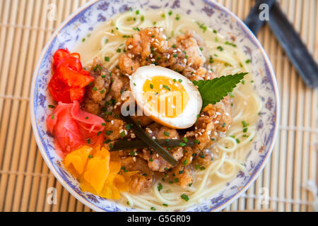 Chicken ramen topped with roast chicken, egg and pickles Stock Photo