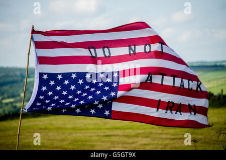 An American flag with the words don't bomb Iran sewn upon it. Taking during a Fourth of July protest at Menwith Hill Stock Photo