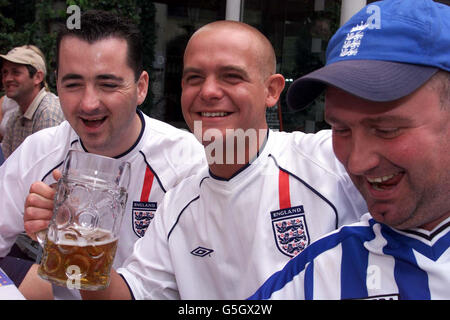 English football fans enjoying themselves in the centre of Munich before the Germany v Engalnd World Cup Qualifier. 10/06/2004 The number of workers phoning in sick with hangovers is expected to increase dramatically on Monday June 14 after England's opening match in the Euro 2004 soccer tournament, a leading employment agency warned Thursday June 10, 2004. Pertemps said the Sunday evening kick-off against France will encourage workers to over-indulge watching the game leading to an expected big rise in the number of people pulling a 'sickie' on Monday. Stock Photo