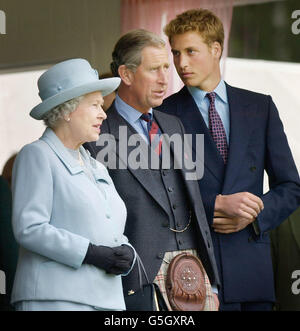 From left - Queen Elizabeth II, The Prince of Wales and Prince William stand in the pavillion at the Braemar Games in Royal Deeside, Scotland. Stock Photo