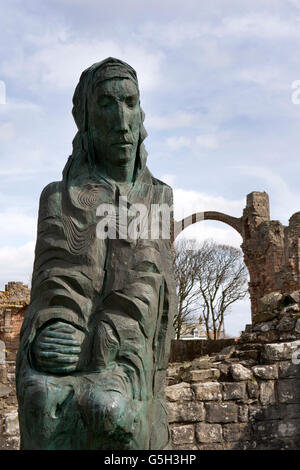 UK, England Northumberland, Holy Island, Lindisfarne Priory, statue of Saint Cuthbert by Fenwick Lawson Stock Photo