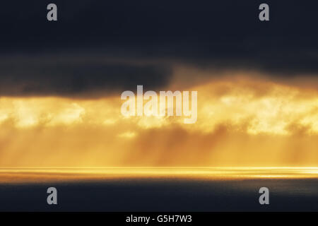 golden sun rays on the sea at the sunset Stock Photo
