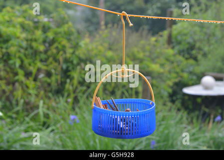 Washing line and clothes peg bag in the rain. England. UK Stock Photo
