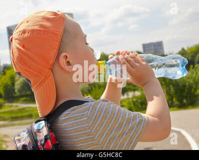 Child drinking pure water in a park Stock Photo