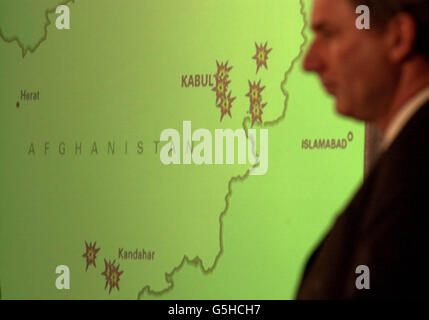 Defence Secretary Geoff Hoon stands in front of a screen at a Ministry of Defence press conference in London. The map shows enemy terrorist training camps successfully destroyed by Allied Forces in Afghanistan. Stock Photo