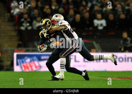 St Louis Rams' Austin Pettis is tackled by New England Patriots' Tavon Wilson during the NFL International Series match at Wembley Stadium, London. Stock Photo